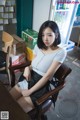 A woman sitting at a desk in a room.