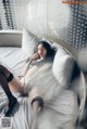 A woman laying on top of a bed in lingerie.