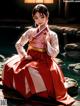 A woman in a red and white kimono sitting on a rock.